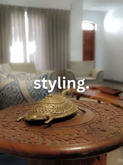 Styling done right. A close-up of a carved wooden table with a decorative brass turtle, showing how small decor items can add personality and charm.