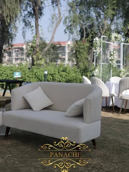 A comfortable and stylish lounge sofa for guests, in a neutral tone to complement the all-white decor.