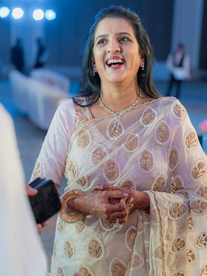 The mother of the bride, looking radiant and happy. We chose a beautiful sheer organza saree with delicate gold embroidery for her, a look that is both elegant and comfortable for a long day of celebrations.