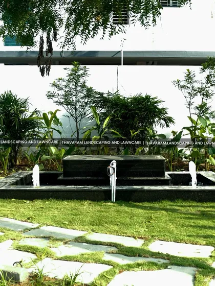 A water feature can transform a garden into a tranquil sanctuary. I installed this elegant, dark stone fountain as a calming focal point, surrounded by a manicured lawn and a variety of green foliage to create a peaceful atmosphere.