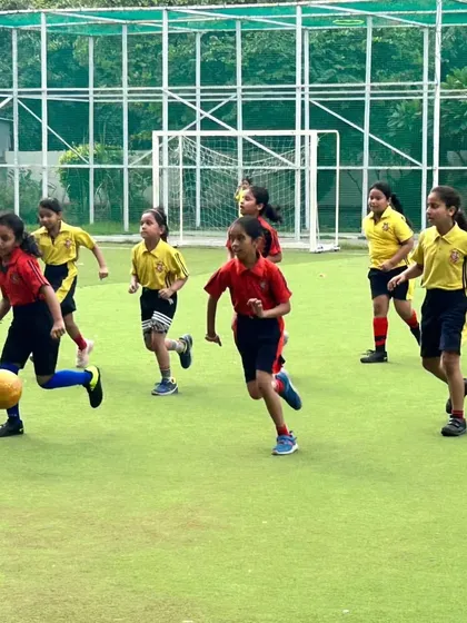 Young female athletes chase the ball on our expansive football field. Our sports program encourages active participation and helps students develop their skills in a supportive environment.