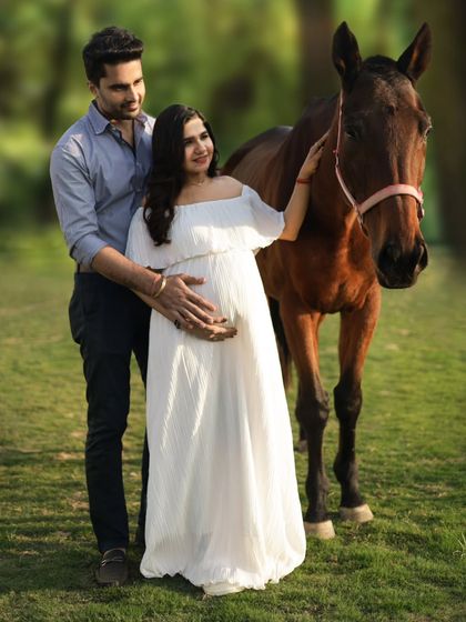 A classic couple pose during our equine maternity session. We guide you into comfortable positions that beautifully showcase the baby bump and the connection between you and your partner.