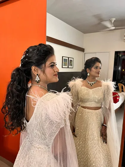 Another angle of this stunning reception hairstyle. The reflection in the mirror shows how the look comes together, exuding confidence and style.
