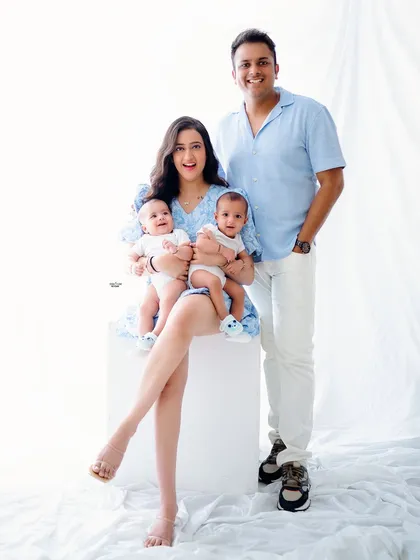 A full-length family portrait showcasing this lovely family and their twin boys.