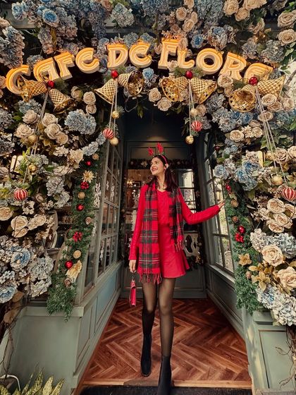 Feeling the Christmas spirit in a festive all-red outfit. I layered a red sweater over a red skirt and paired it with a plaid scarf for a cozy and cheerful holiday look.