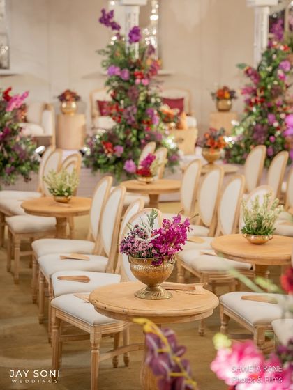 Another view of the ceremony seating, showcasing the neat rows of chairs and the vibrant floral arrangements that add pops of color throughout the space.