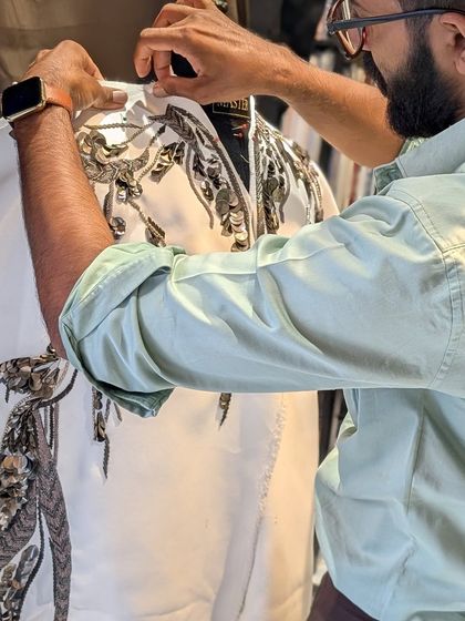 A moment of focus as I work on the intricate metal and thread embroidery for a custom jacket. This hands-on approach ensures the highest quality and attention to detail in every piece.