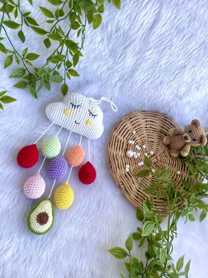 The cloud mobile displayed with a little teddy bear to show its playful, gentle vibe.