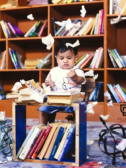 Let's get creative with a themed photoshoot. This fun, library-themed session was designed to capture this little one's curious and playful personality.
