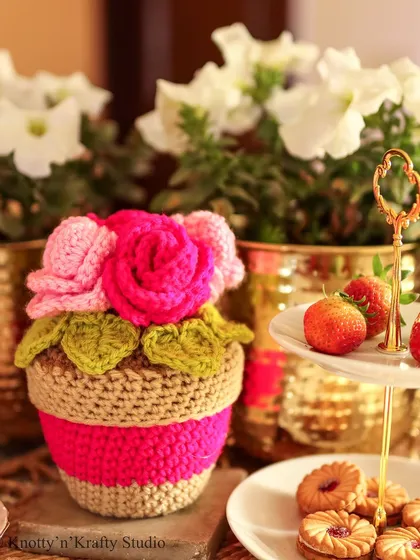 A sweet bunch of Rosie Posies in a crochet pot. This little floral arrangement is perfect for a tea party tablescape or as a permanent bouquet on a side table.