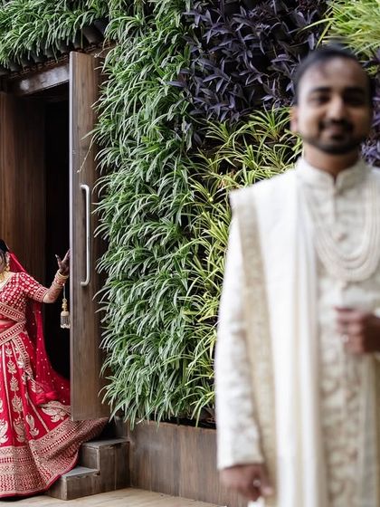 The groom's reaction during the 'first look' is priceless. This shot captures his anticipation as his bride makes her entrance.