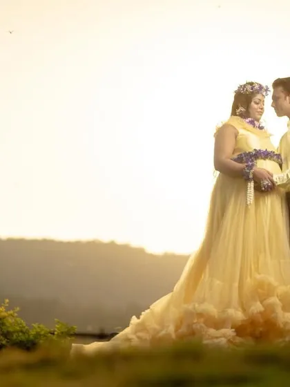 A silhouette-style couple shot against a golden hour sunset. The beautiful light and natural landscape create a breathtakingly romantic portrait.