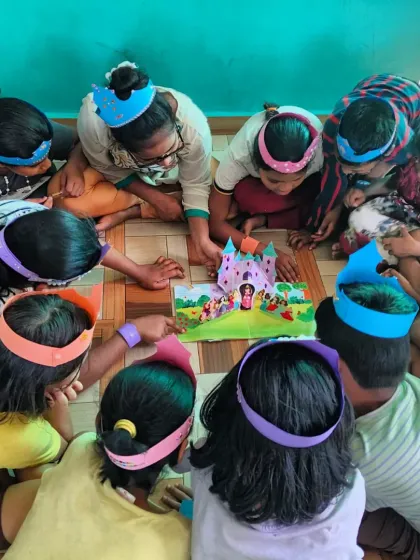 Children gather around a pop-up castle, their eyes wide with wonder. Interactive books and follow-up activities make the stories more tangible and memorable, helping to heal and empower.
