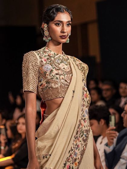 A beautiful traditional look for The Luxo Show. The makeup features a deep, bold lip and defined eyes, complementing the intricate embroidery and traditional nose ring.