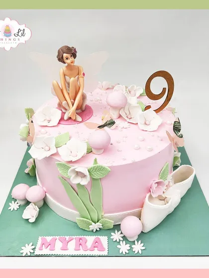 A whimsical fairy cake for Myra's 9th birthday, featuring a delicate fairy, ballet slippers, and soft floral details.