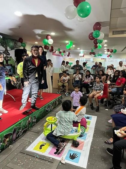A corporate family day is the perfect setting for my show. Here, I have a mix of kids and adults on stage, all participating in a trick together, with the rest of the office cheering them on.