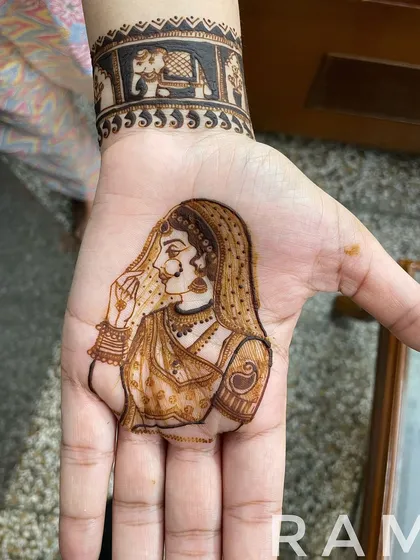 The completed portrait of a royal bride, with delicate shading on her lehenga and jewelry. This design is placed on the palm, complemented by a traditional elephant band on the wrist.