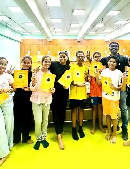 A group of smiling campers with their certificates and coaches. I make sure to celebrate the completion of the camp to give every child a sense of achievement.
