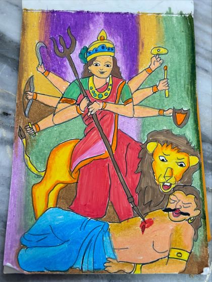 A close-up of the Goddess Durga drawing, highlighting the details and colours used to depict this strong and divine figure.