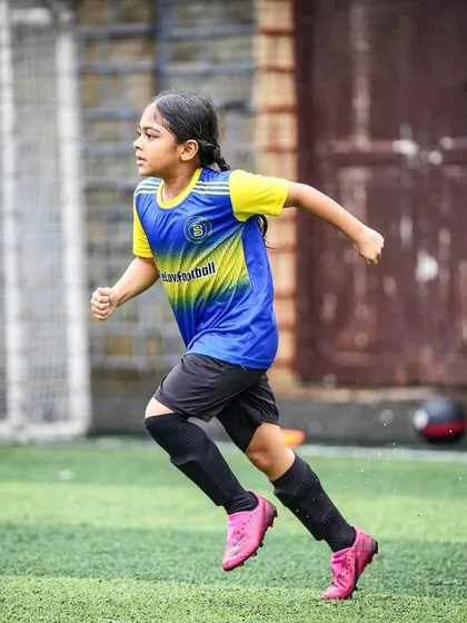 A young star from our Girls Program runs with determination on the pitch. This action shot highlights the talent and bright future of the female players we nurture at Bravo.