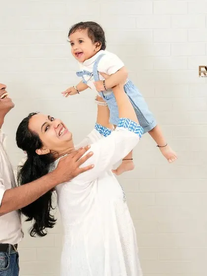 We believe the best family portraits capture the moments in between the poses. This candid shot of a family playing together, filled with laughter and movement, shows the authentic, loving energy that makes your family unique.