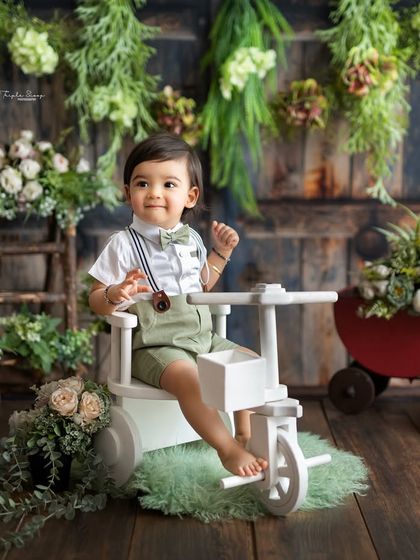 A handsome little boy on his white tricycle. Using props like this adds a fun element to the session and results in great, interactive photos.