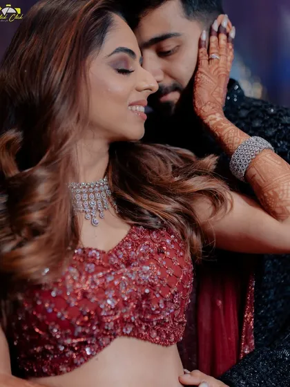 An intimate sangeet portrait, capturing the tender connection between the couple. Her hand on his cheek, his smile says it all.