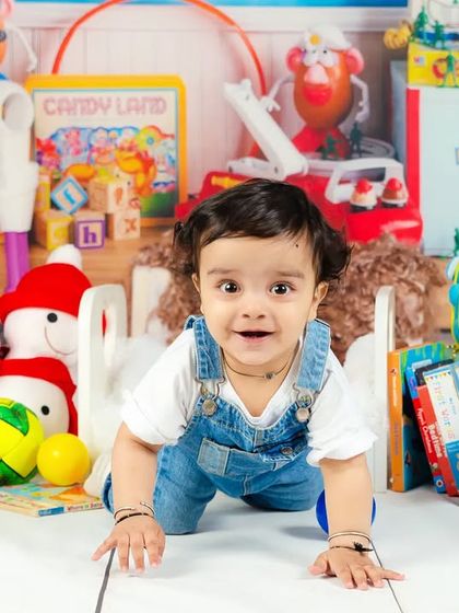 A baby boy crawls through a room full of colorful toys, his face lit up with excitement and curiosity. A perfect "Toy Story" inspired scene.