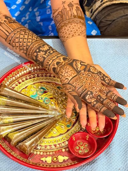 Another shot of the bride's hands over the henna tray, showing the fresh application.