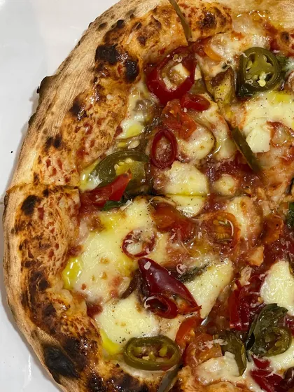 For those who like it hot. This pizza is loaded with spicy red and green chili peppers, adding a serious kick to every slice.