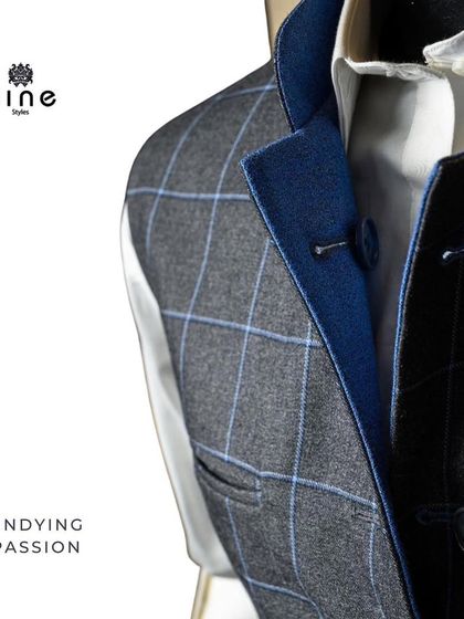 A close-up of a grey plaid waistcoat with blue lining. This shows how we use contrasting fabrics and patterns to add a hidden touch of style.