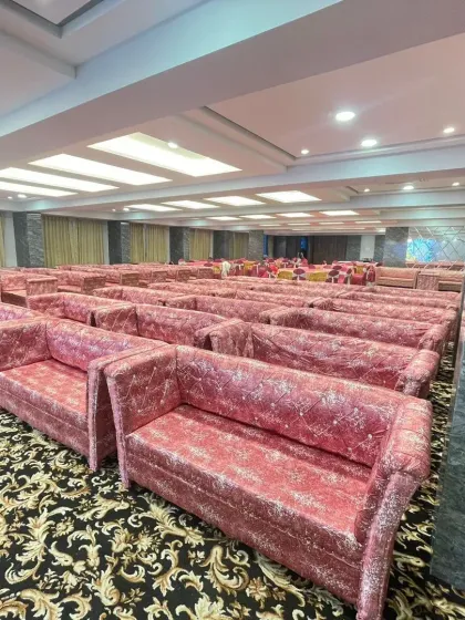 The seating arrangement at Palm Beach banquet hall in Vashi, featuring pink sofas. This hall offers multiple floors and flexible packages to suit your event size and budget.