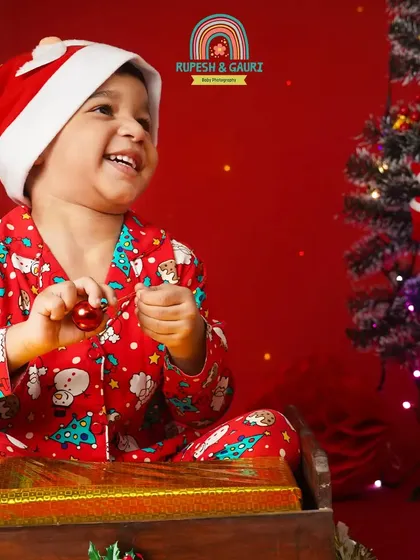 The pure joy of Christmas. This little boy's happy laugh is infectious in our festive red Christmas setup.