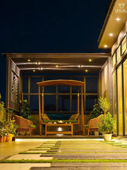 I create cozy corners for you to unwind. This custom pergola houses a beautiful wooden swing and comfortable seating, lit by warm, subtle LEDs, making it the perfect spot for quiet evenings.