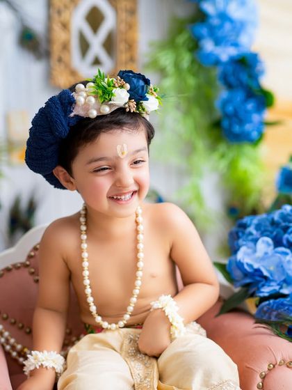 The pure, innocent smile of a child dressed as Krishna. I focus on capturing their natural expressions and playful energy during these festive sessions.