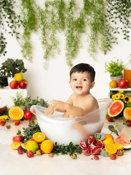 A fruit bath is a feast for the senses! This little boy is having a great time exploring all the different fruits in his tub during this colorful summer shoot.