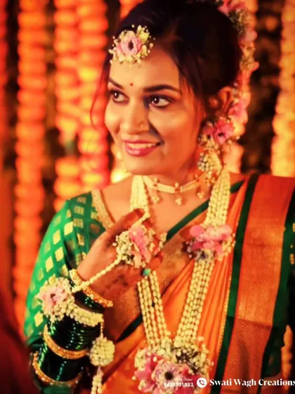 A close-up of this happy bride. You can see the detail in her floral necklace and hathphool, designed to be both intricate and comfortable.