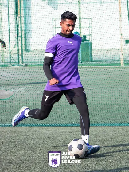 Experience the thrill of the game on our premium football turfs. This action shot from the Just Fives League captures a player in motion, highlighting the quality surface ideal for fast-paced 5-a-side football.