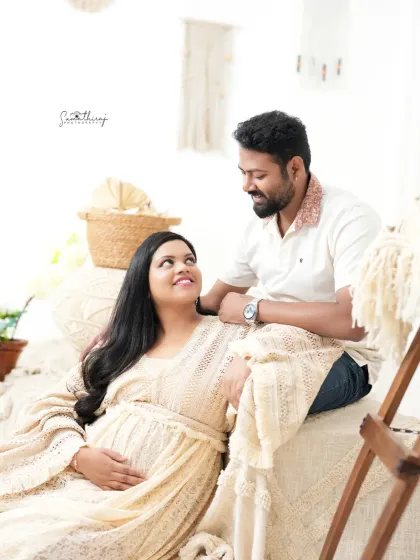 A joyful and relaxed couple portrait in our boho-chic studio. Their happy expressions and the cozy setting make for a heartwarming and stylish memory.