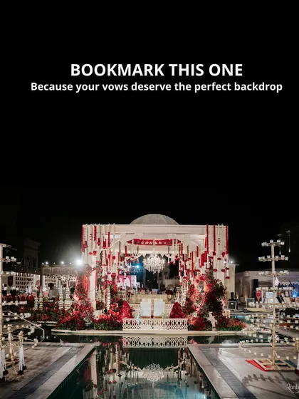 We transform magnificent venues into sacred spaces for your vows. This poolside mandap, set against the night sky with dramatic red florals and a cascading crystal chandelier, reflects our passion for creating opulent and deeply romantic wedding ceremony backdrops.