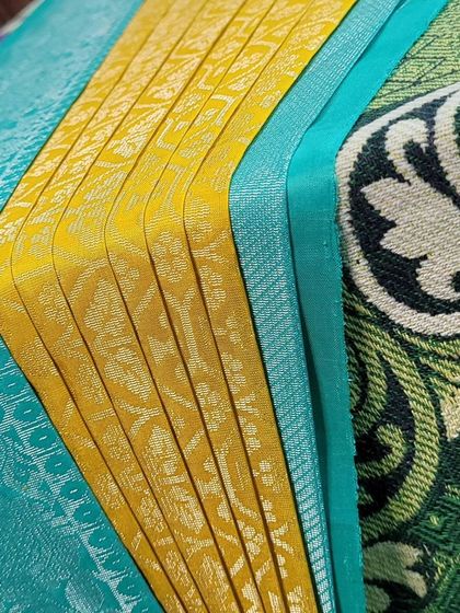 A close-up of the crisp pleats on a pre-pleated silk saree.