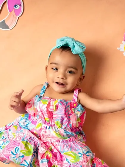 Getting into the summer spirit with a vibrant flamingo and beach theme! This little girl looks adorable in her colorful dress and matching headband.