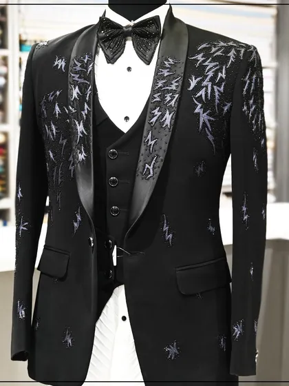 This black three-piece tuxedo is for the bold. It features abstract, lightning-like embroidery in a contrasting thread, creating a dynamic and energetic look.