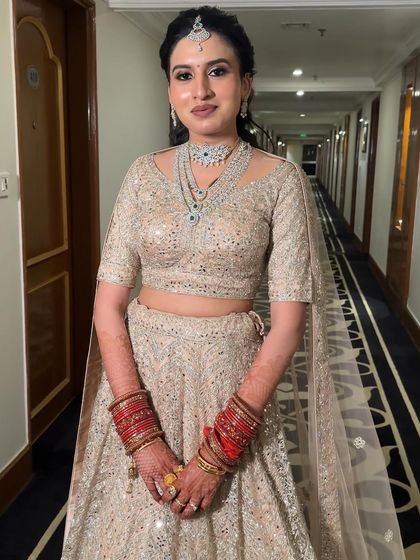 The complete reception look, showcasing the beautiful harmony between the intricate ivory lehenga, the sparkling diamond jewelry, and the soft, minimal makeup.