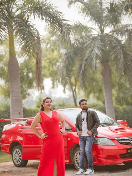 A classic, stylish pose with a red convertible and palm trees, perfect for a high-fashion pre-wedding concept.