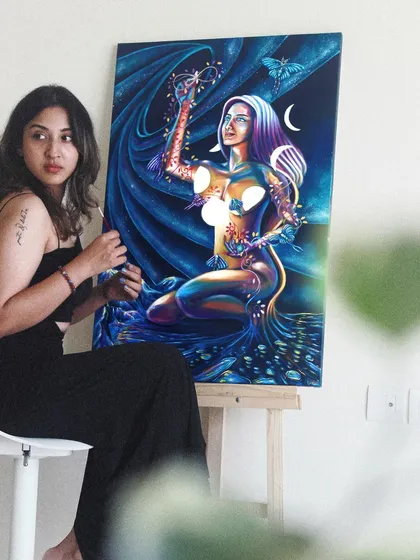 This piece is about the joy of creating your own reality. A soul in the form of a woman joyfully plucks planets from the sky, embracing her power to shape her world. It’s a reminder to find the fun in living.