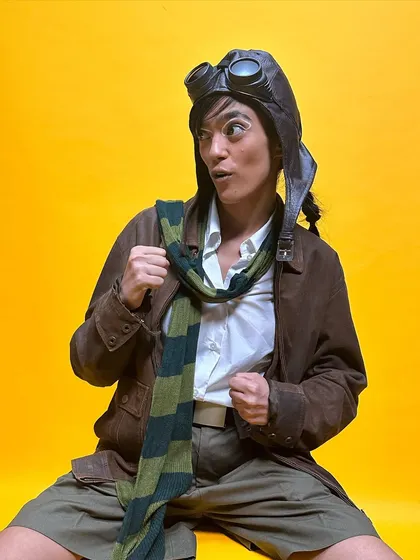 A fun, character-driven shot from the 'Faramōsh' music video. The makeup helps bring the whimsical, aviator-inspired character to life.