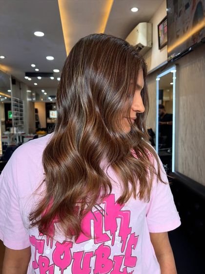 A side profile of the beige chocolate balayage, showing how the lighter pieces frame the face.