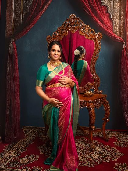 Standing with regal poise, this mother-to-be is the picture of grace. The reflection in the ornate mirror adds a beautiful layer to this heritage-themed maternity portrait.