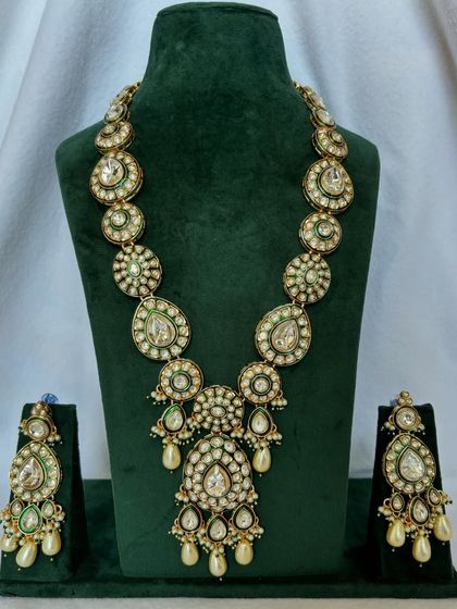 A long Polki necklace set with matching earrings. This rental set is perfect for adding a touch of royalty to your wedding ensemble.